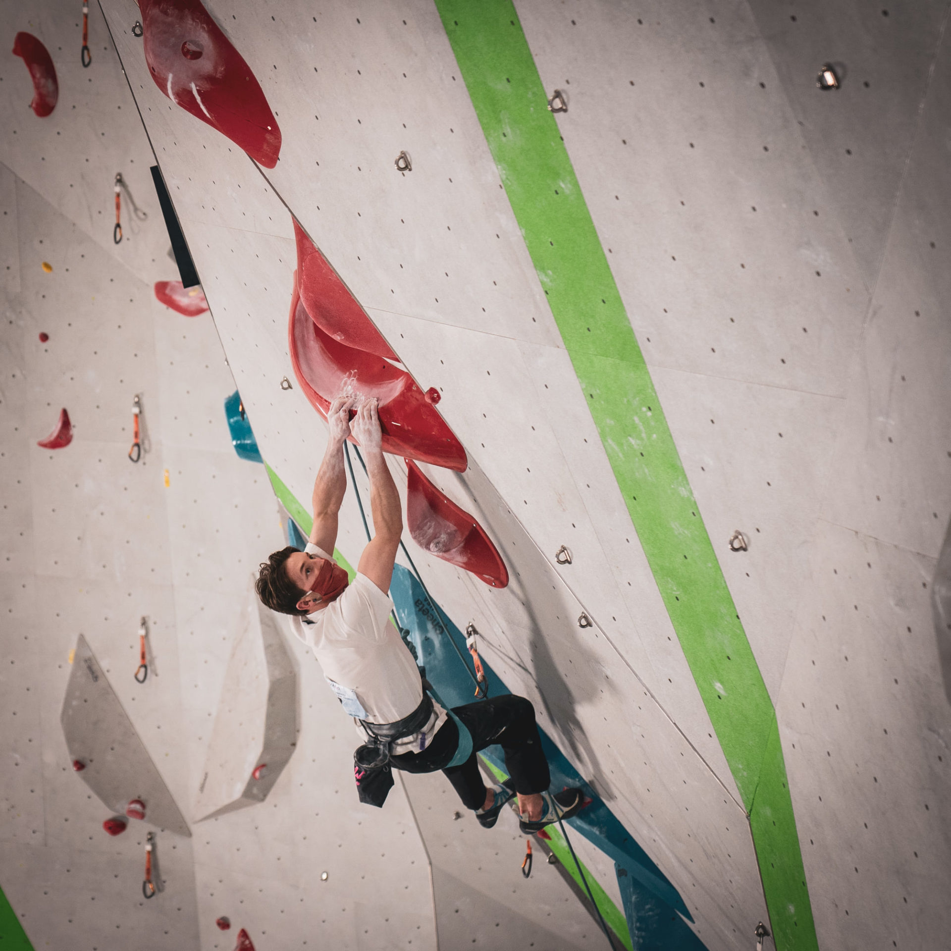 Male competitor on climbing wall