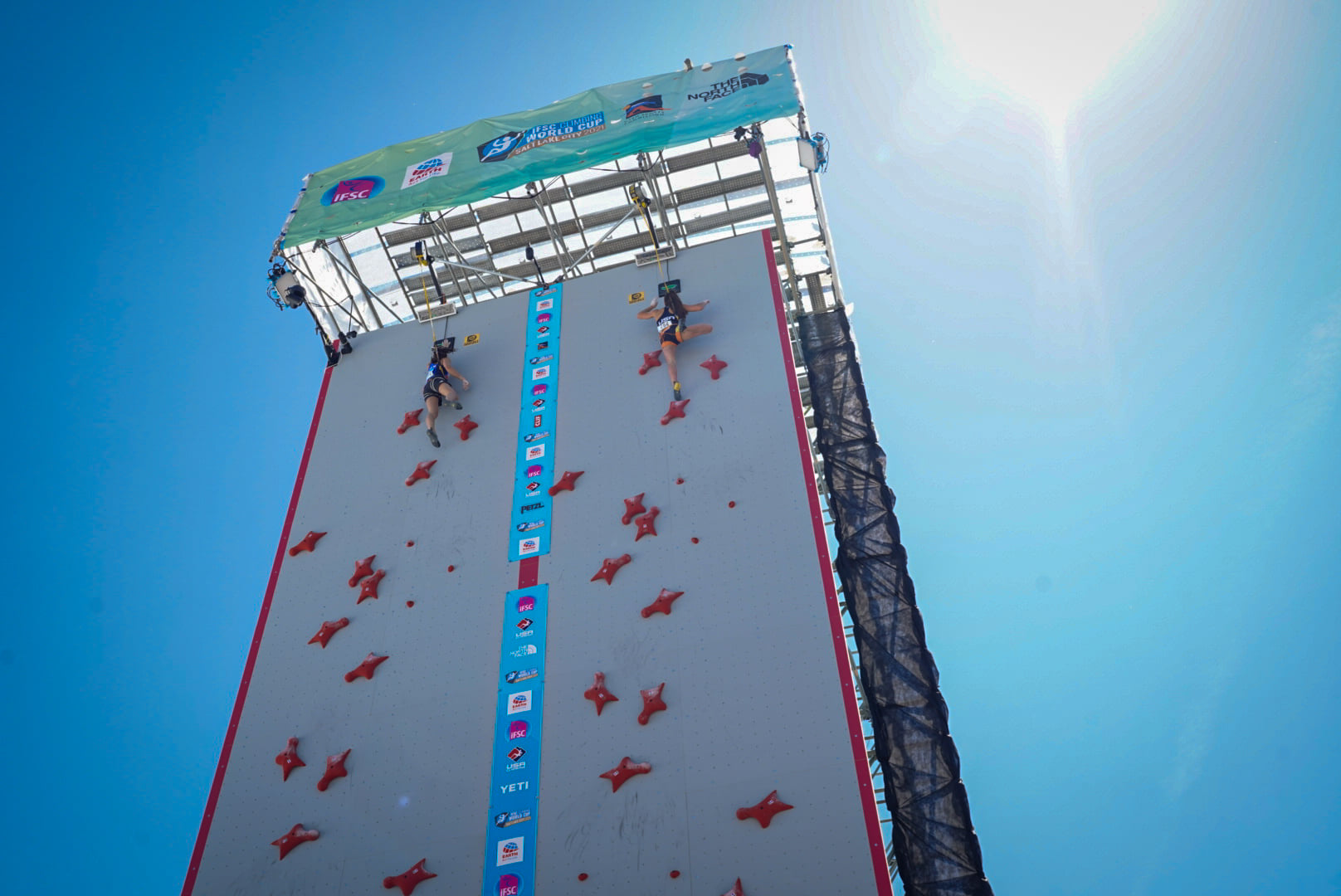 Two female competitors on outdoor climbing wall